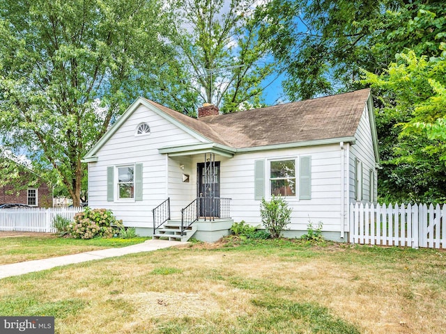 bungalow-style house with a front lawn