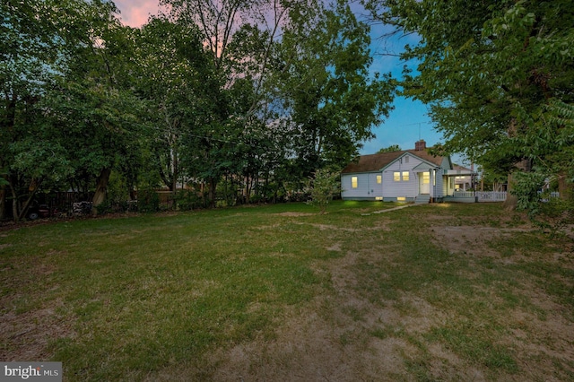 view of yard at dusk