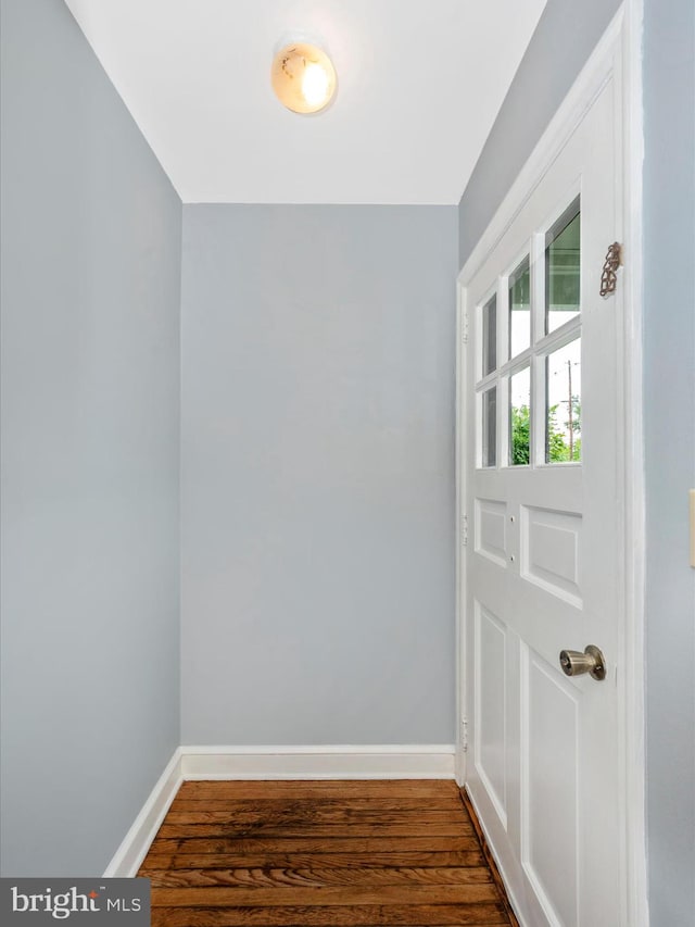 doorway with dark wood-type flooring