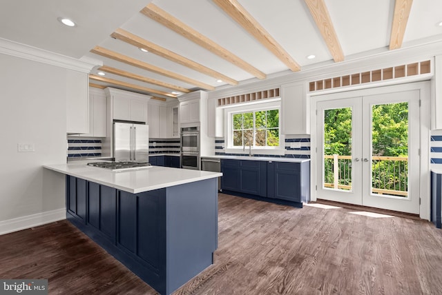 kitchen with tasteful backsplash, stainless steel appliances, white cabinets, french doors, and dark hardwood / wood-style flooring