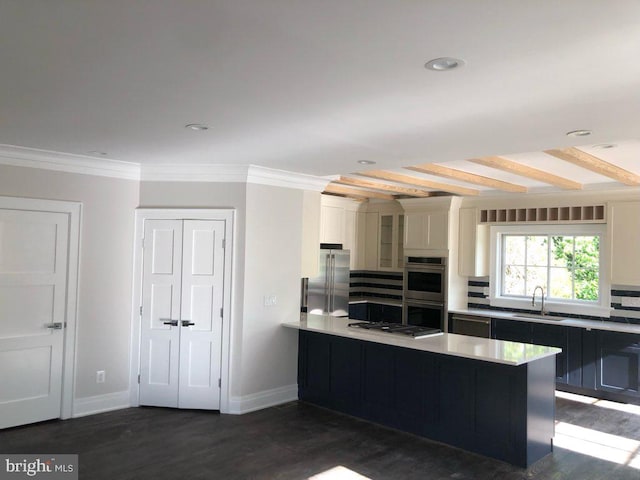 kitchen featuring white cabinets, stainless steel appliances, kitchen peninsula, dark hardwood / wood-style floors, and beam ceiling