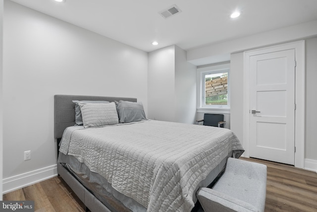 bedroom with dark wood-type flooring