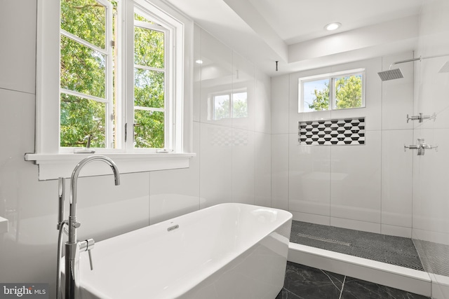 bathroom featuring plus walk in shower and tile patterned flooring