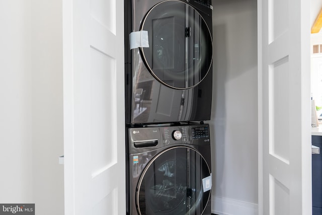 laundry area with stacked washer / dryer