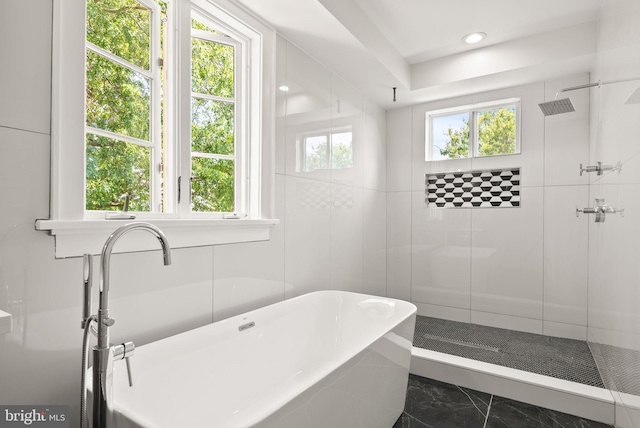 bathroom featuring tile patterned flooring and separate shower and tub