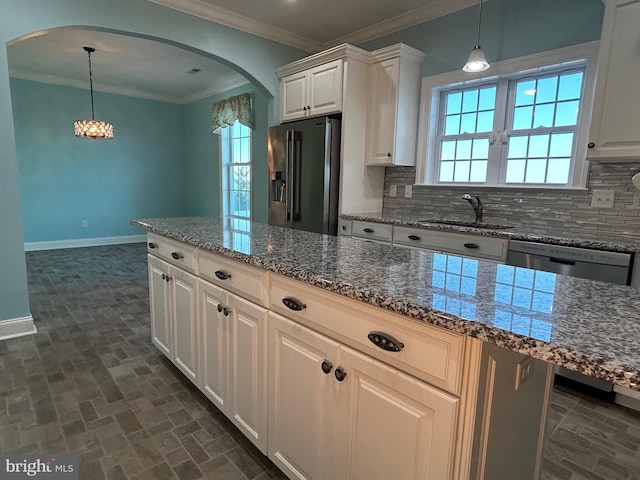 kitchen featuring white cabinets, appliances with stainless steel finishes, tasteful backsplash, and sink