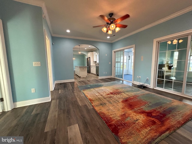 interior space with ceiling fan, dark hardwood / wood-style flooring, and ornamental molding