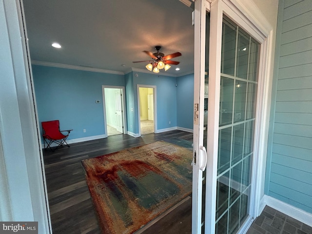 interior space featuring ceiling fan, dark hardwood / wood-style floors, and ornamental molding