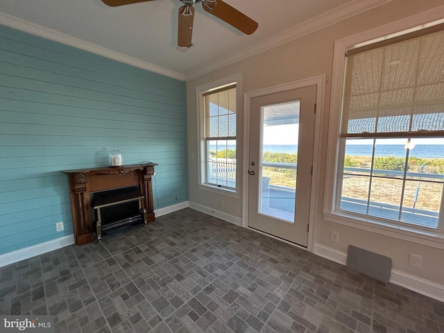 doorway featuring ceiling fan, wood walls, a water view, and crown molding