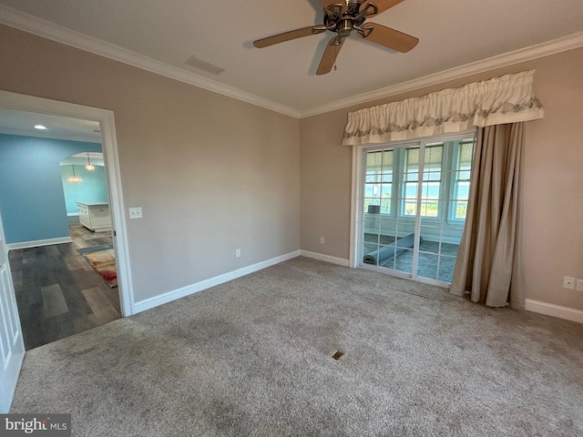 carpeted empty room featuring ceiling fan and crown molding