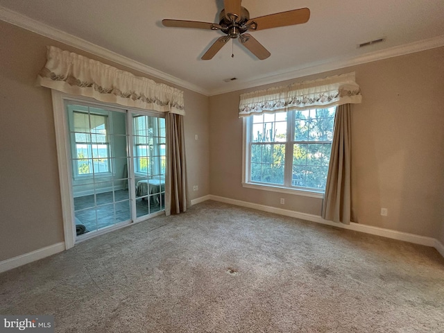 carpeted spare room featuring ceiling fan and crown molding