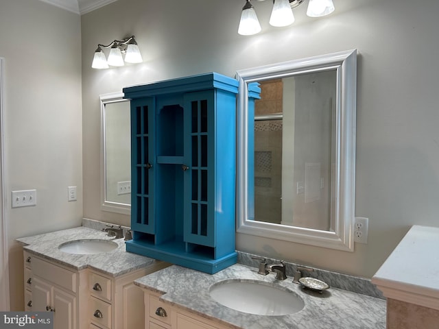 bathroom with vanity, a shower with door, and ornamental molding