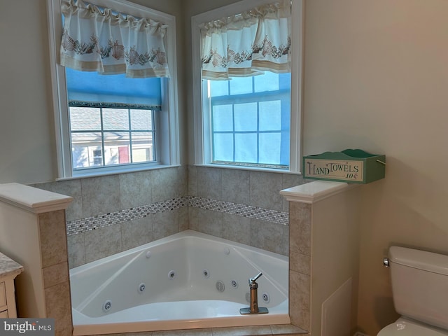 bathroom with a relaxing tiled tub and toilet