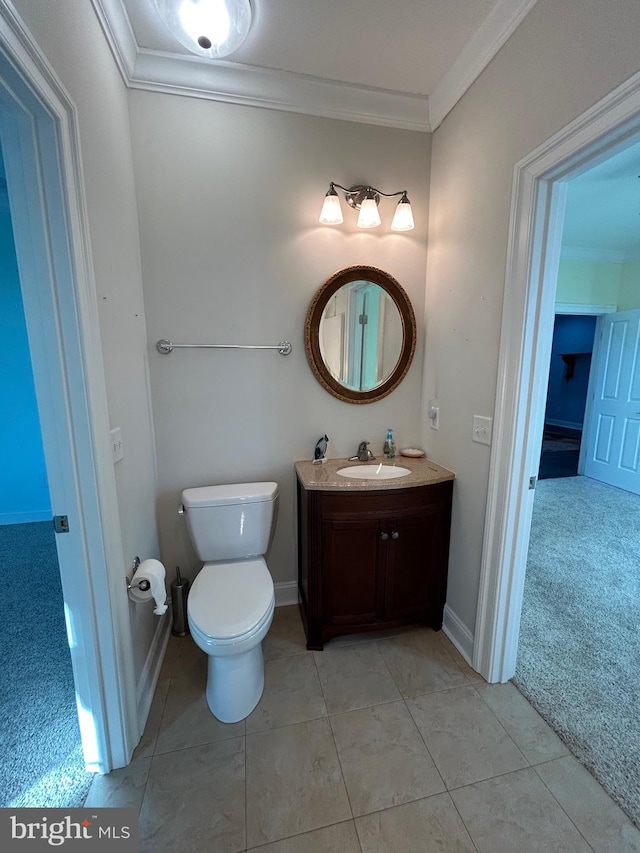 bathroom with tile patterned flooring, vanity, and ornamental molding