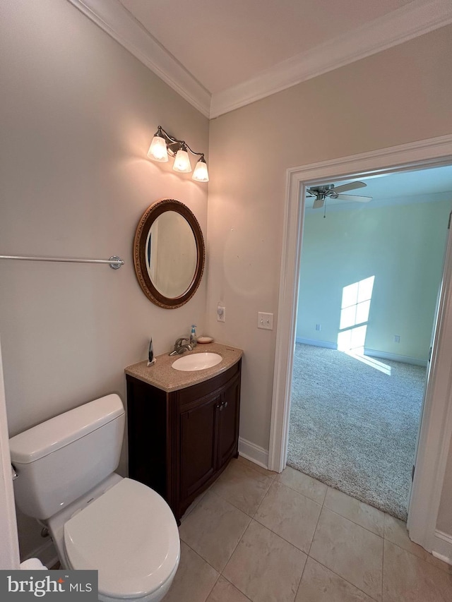 bathroom featuring ornamental molding, vanity, ceiling fan, tile patterned flooring, and toilet