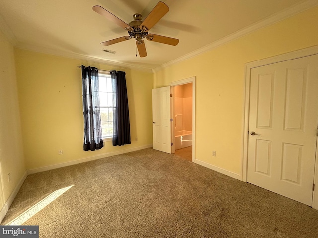 unfurnished bedroom featuring ceiling fan, carpet, ensuite bathroom, and ornamental molding