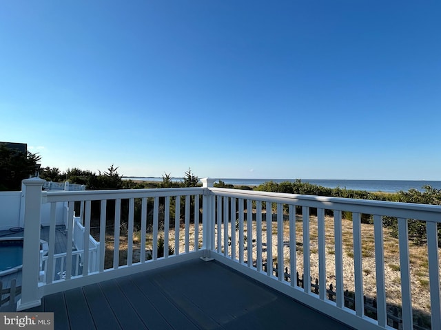 wooden terrace featuring a water view