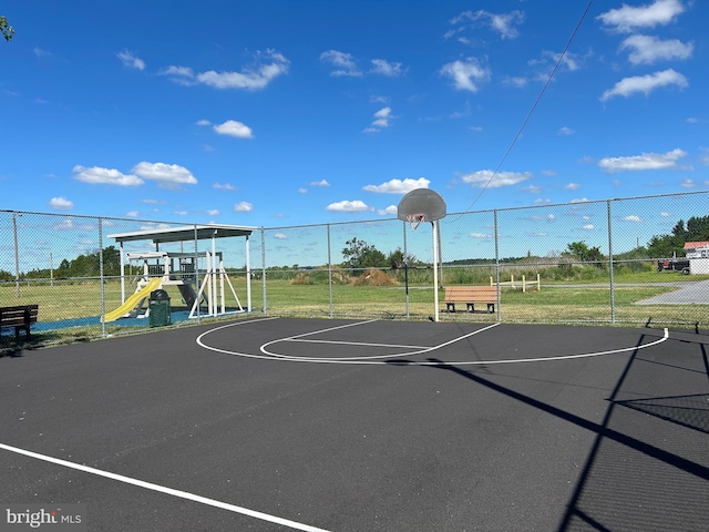 view of sport court with a playground