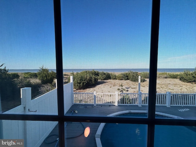 view of swimming pool featuring a water view