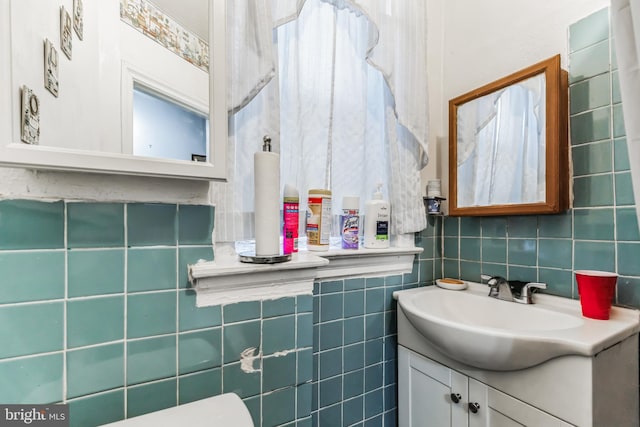 bathroom with vanity, tile walls, and tasteful backsplash