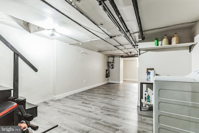 basement featuring light hardwood / wood-style floors and washer / dryer