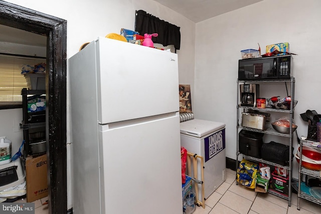 kitchen featuring white refrigerator and light tile patterned flooring