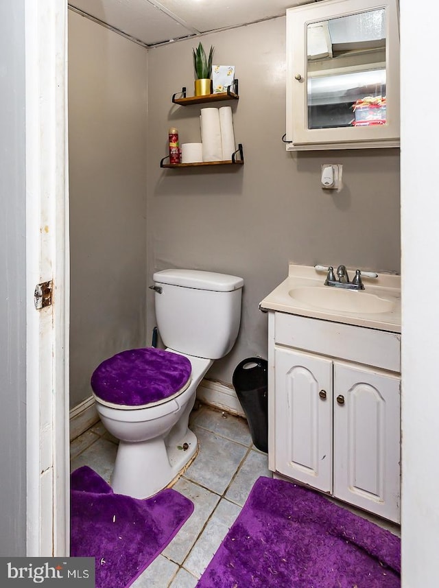 bathroom featuring tile patterned floors, vanity, and toilet