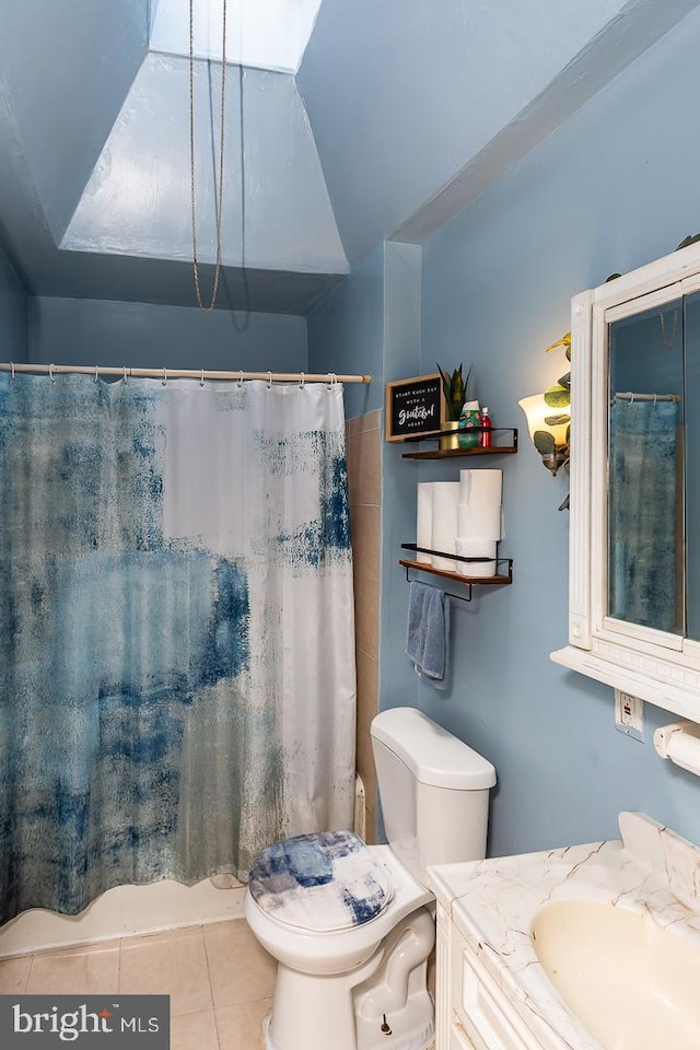 bathroom with tile patterned floors, vanity, and toilet