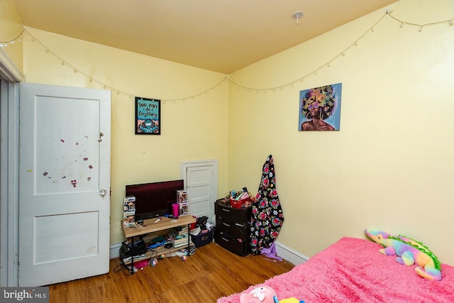 bedroom with hardwood / wood-style floors