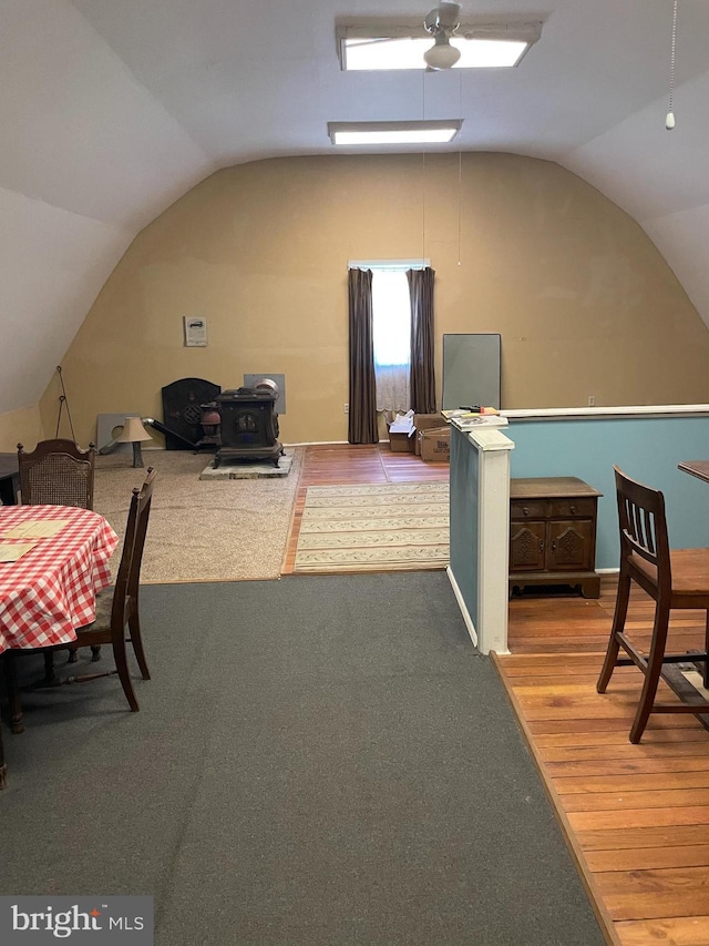 additional living space with carpet floors and vaulted ceiling