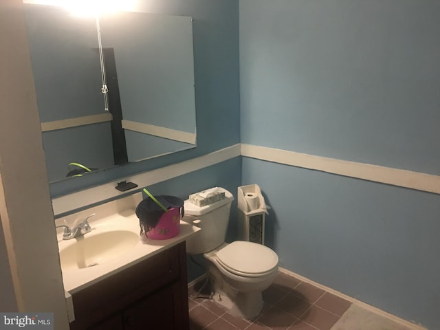 bathroom featuring tile patterned floors, vanity, and toilet