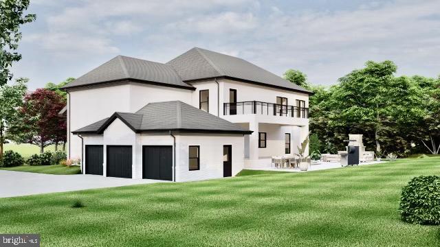 rear view of house with a yard, a balcony, and a garage