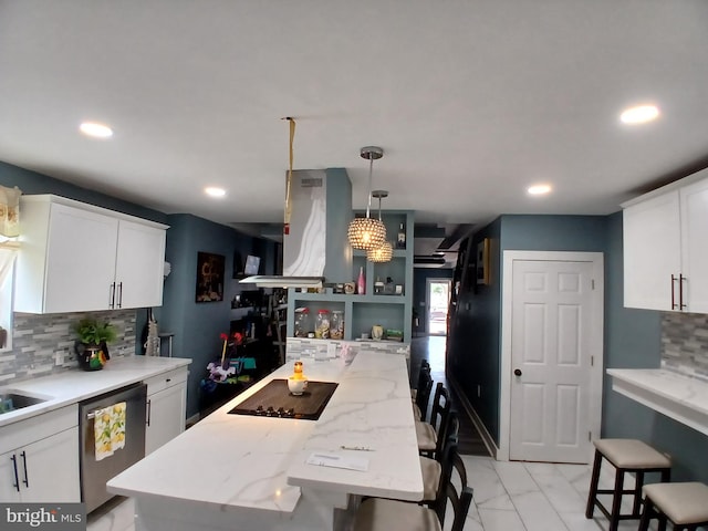 kitchen featuring white cabinets, ventilation hood, stainless steel dishwasher, decorative backsplash, and a breakfast bar area