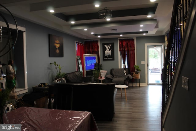 living room featuring hardwood / wood-style floors and a raised ceiling