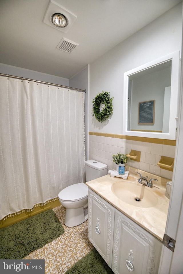 bathroom with tile walls, tile patterned floors, vanity, and toilet