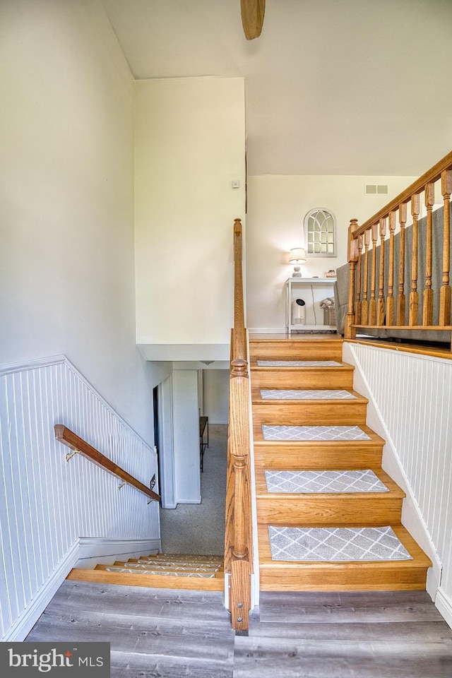 stairs featuring hardwood / wood-style flooring