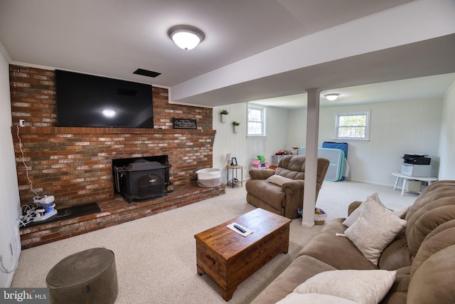 living room with a wood stove and light colored carpet