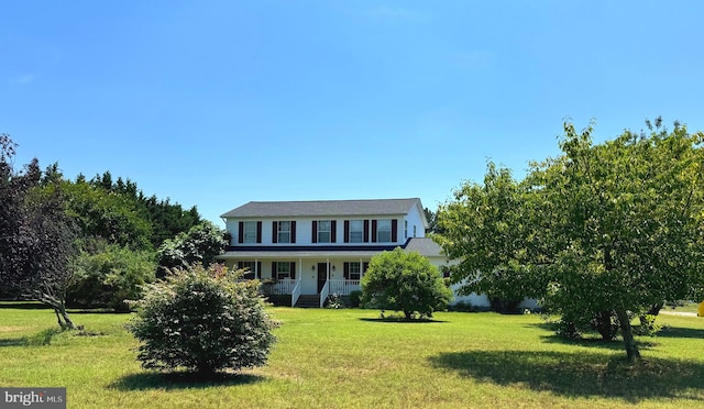 colonial home with covered porch and a front lawn