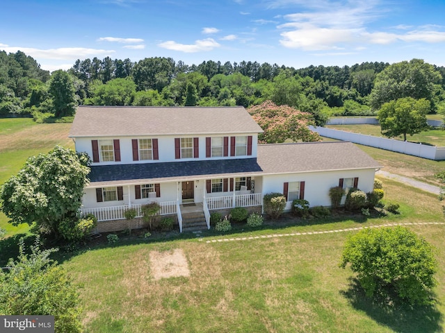 view of front of property with covered porch and a front lawn