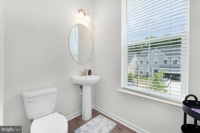 bathroom featuring hardwood / wood-style flooring, sink, and toilet