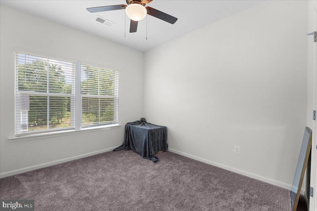 unfurnished room with light carpet, a wealth of natural light, and ceiling fan