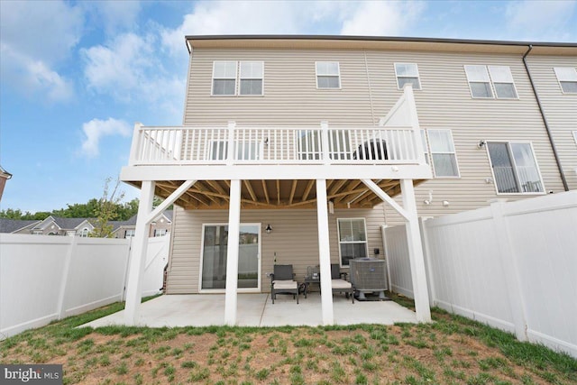 back of house featuring central AC unit, a patio area, and a wooden deck