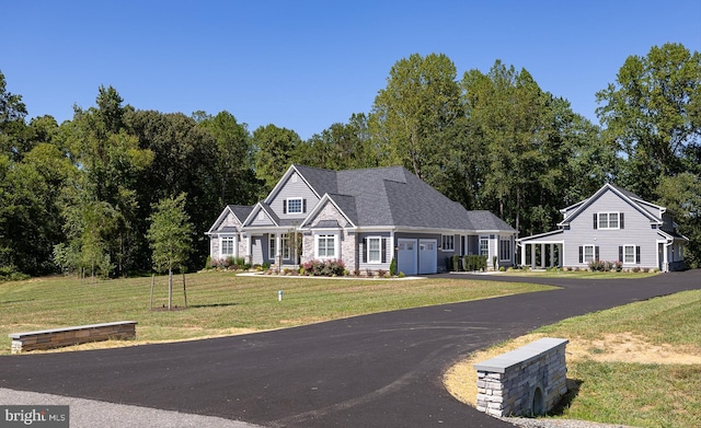 view of front of property featuring a garage and a front lawn