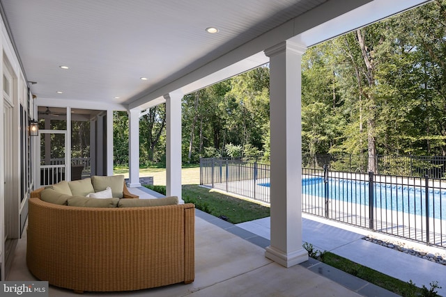 view of patio with an outdoor living space and a fenced in pool