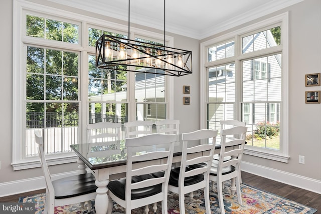 dining space featuring ornamental molding, dark wood-type flooring, and a chandelier