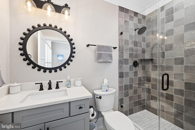 bathroom featuring vanity, toilet, and an enclosed shower