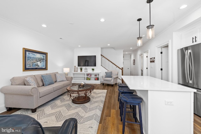 living room with crown molding and dark hardwood / wood-style floors