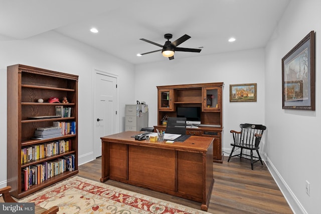 office area featuring ceiling fan and dark wood-type flooring