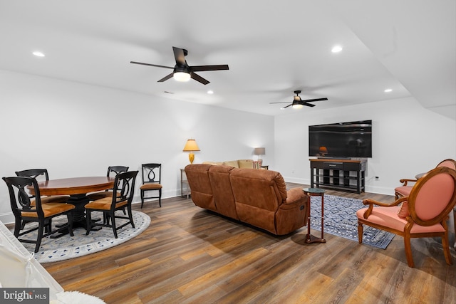 living room with ceiling fan and dark hardwood / wood-style flooring