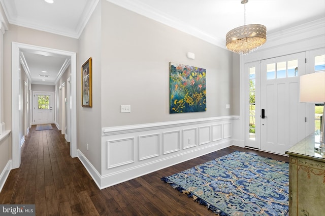 foyer entrance with a chandelier, dark hardwood / wood-style floors, and plenty of natural light